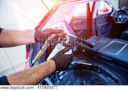 A Car Service Worker Cleans Interiror With A Special Foam Generator