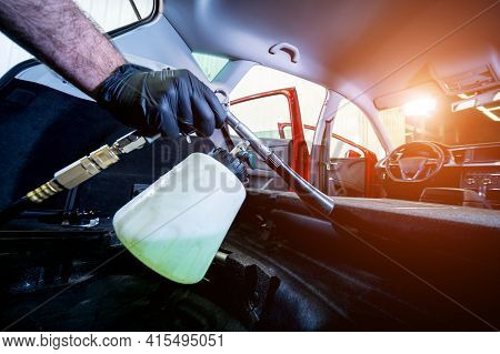 A Car Service Worker Cleans Interiror With A Special Foam Generator