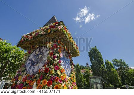 The Famous Clock Tower, One Of The City Of Graz Attractions, Made Of Flowers And The Real Clock Towe