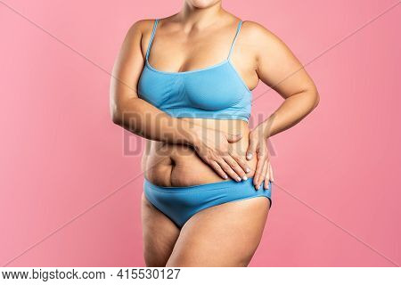 Fat Woman In Blue Underwear On Pink Background, Overweight Female Body