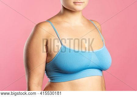 Big Natural Breasts In Blue Bra Close-up On Pink Background
