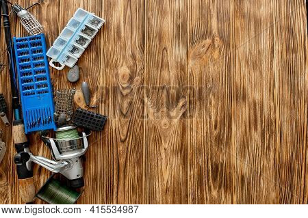 Flat Lay With Fishing Tackle, Fishing Rod And Plastic Box With Fishing Tackle And Hooks, Feeders On