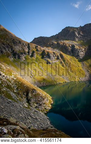 Beautiful Alpine Deep Blue Mountain Lake, Lago Nero, Ticino, Switzerland - Portrait Format, Image