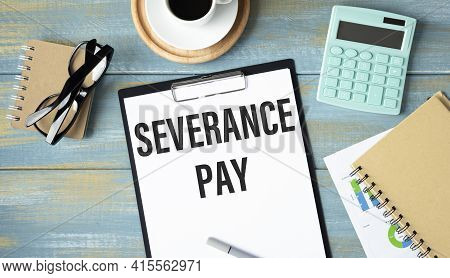 Paper With Severance Pay On A Table