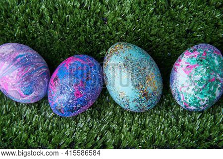Colorful Eggs With Bright Shiny Gliter On Grass