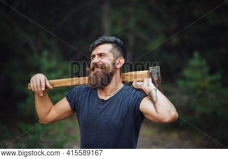 Smiling Stylish Brutal Bearded Man In A Dark Sleeveless T-shirt With A Large Mustache And Gray Hair