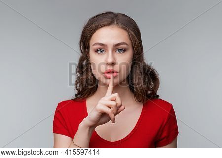 Keep It Quiet. Serious Young Brunette Woman Hiding Secret, Making Hush Silence Shh Gesture, Holding 