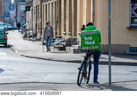 Riga, Latvia - September 30, 2020:wolt Company Food Delivery Worker On Bicycle In Riga City. Wolt Is