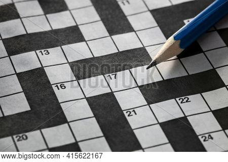 Solving a crossword puzzle with blue pencil background