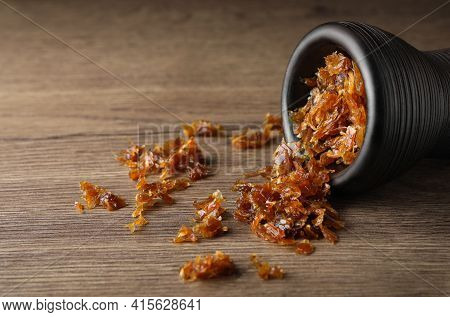 Clay Bowl Of Hookah With Aromatic Tobacco On Wooden Table, Closeup