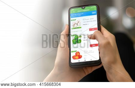 Mogilev, Belarus-march 23, 2021: Woman Orders Fresh Vegetables Through A Mobile Phone App Close-up W