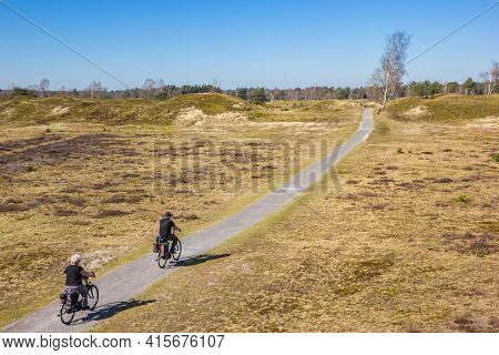 Senior Couple Riding Their Bicycle In The National Park Drents-friese Wold, Netherlands