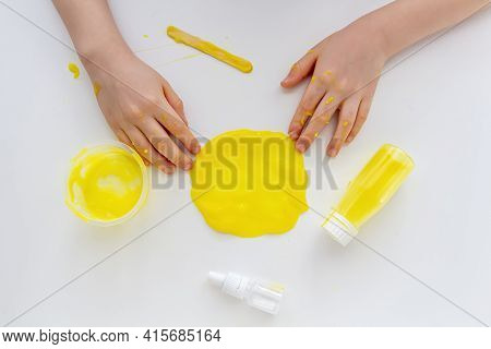 Kid Plays With Homemade Yellow Slime. Child Hands Stretch Slime Toy. Make Slime At Home. Diy And Chi
