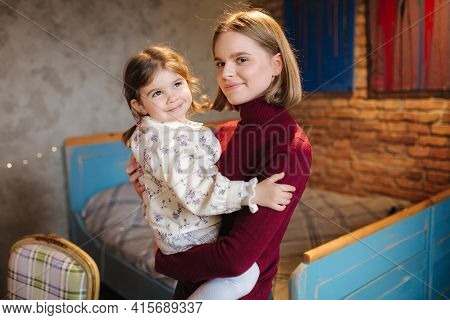 Adorable Little Girl Hug Her Beautiful And Young Godmother. Portrait Of Happy Woman Hug Her Goddaugh