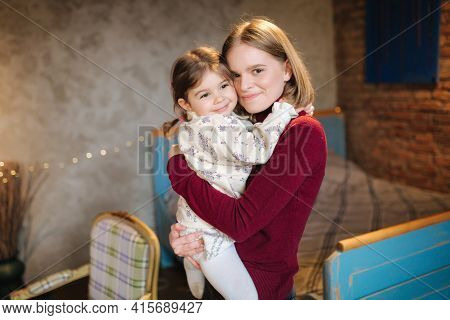Adorable Little Girl Hug Her Beautiful And Young Godmother. Portrait Of Happy Woman Hug Her Goddaugh