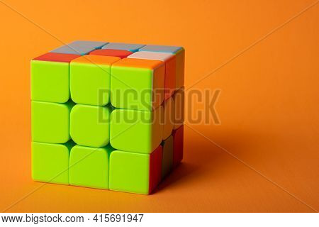 Araras, São Paulo, Brazil, April 4, 2021, A Magic Cube With A Correct Face On An Orange Background A