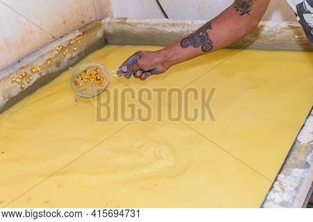 Man's Hand With A Strainer Cleaning Water After Cooking Corn