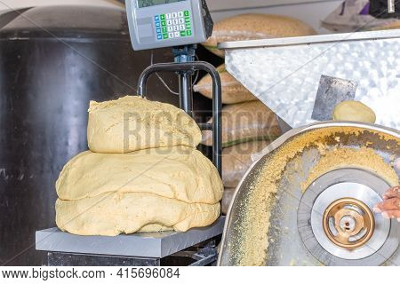 Front View Of A Nixtamal Mill And A Scale Weighing Dough
