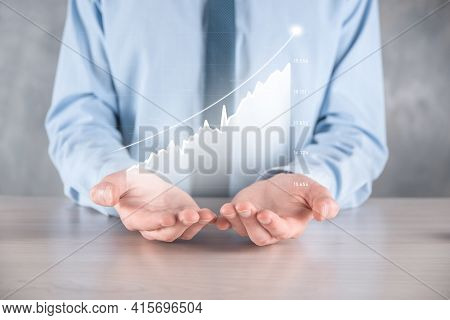 Businessman Man Holding A Graph With Positive Profits Growth. Plan Graph Growth And Increase Of Char