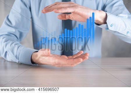 Businessman Man Holding A Graph With Positive Profits Growth. Plan Graph Growth And Increase Of Char