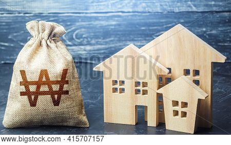 Bag With The Money And The Word Taxes And Wooden Houses. Taxes On Real Estate, Payment. Penalty, Arr