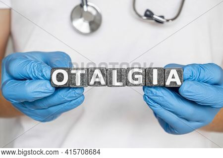 Otalgia - Word From Stone Blocks With Letters Holding By A Doctor's Hands In Medical Protective Glov