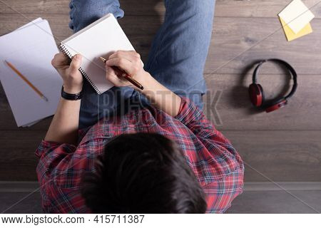 Man writing in notebook noting thinking idea solitions. Student man online larning. Creative inspiration study concept