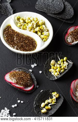 Superfood. A Healthy And Original Snack. Black Chips With Natural Charcoal With Chia Seed Caviar And
