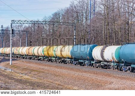 Long Freight Train Approaches To The Station.