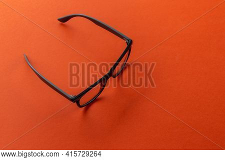 Eyeglasses On Orange Background, Myopia Or Presbyopia.  Eyesight Correction. Fashion Accessories.