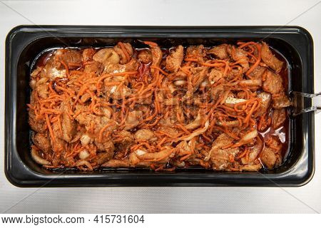 Marinated korean Hwe salad with zander fish in plastic container