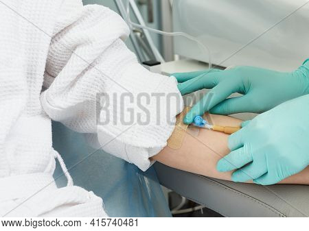 Beautician Inserts A Needle Into A Patients Vein In Order To Draw Blood For Cosmetic Procedures And 