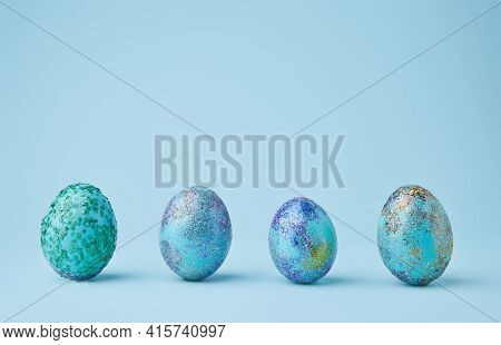 Blue Painted Eggs With Bright Shiny Gliter On Blue Background