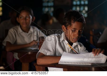 Bluff, Nicaragua. 03-17-2019. Portrait Of A Boy Studying And Doing His Homework At School In The Tow