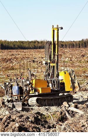 Mini-drilling Rig On Crawler Track On Site Of Sawn Forest Where Large-scale Enterprise Will Be Built