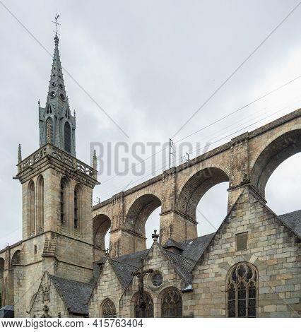 Historic Church Of Morlaix, France, With The Railway Bridge High Above The City