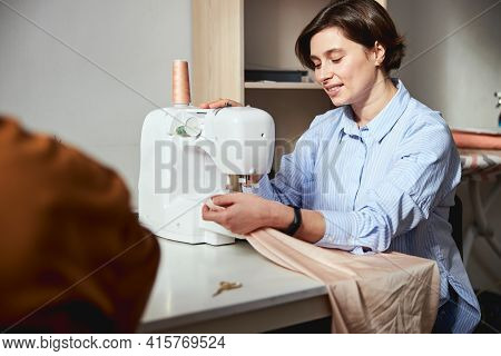 Seamstress Putting Stitches Into A Fabric Sheet