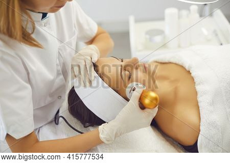 Cosmetologist Making Apparatus Phonophoresis Facail Procedure For Woman In Beauty Salon