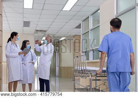 Senior Professional Doctor Consult And Discuss With Woman Doctors In Serious Tumor And Cancer Surger