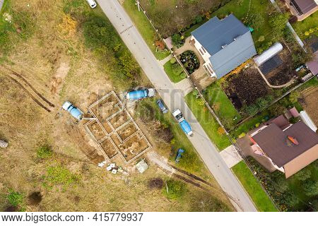 Top Down Aerial View Of Construction Works Of New House Concrete Foundation In Rural Residential Are