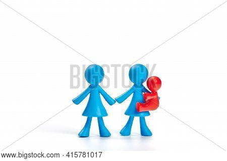 . Toy People Isolated On White Background. The Concept Of Adoption Of Children By Gossexual Families