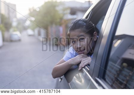 Asian Happy Student Smiling With Camera While Enjoying Road Trip In Car. Daughter Smiling And Lookin