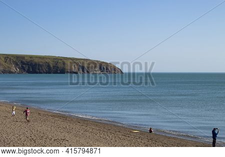 Aberdaron - Wales - April 3 2021 : Seaside View. Holiday Makers Enjoy The Pristine Sands And Beautif