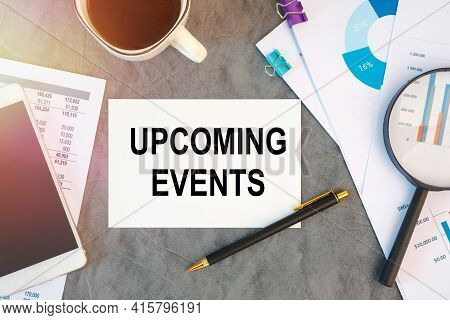 Upcoming Events Is Written In A Document On The Office Desk With Office Accessories, Coffee, Diagram