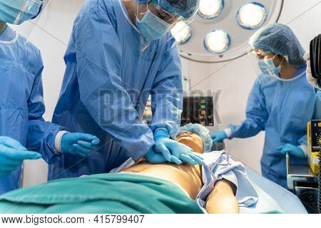 Medical Team In Surgical Gown Help Patient To Making Cpr Cardio Pulmonary Resuscitation In The Opera