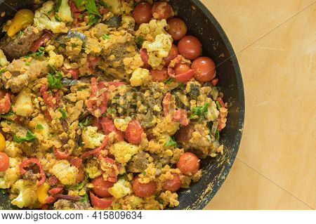 Top View On Frying Pan Full Of Red Lentils Coocked With Vegetables - Red Tomotoes,  Mangold , Parsle