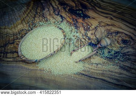 White Amaranth Seed On Brown Olive Wood