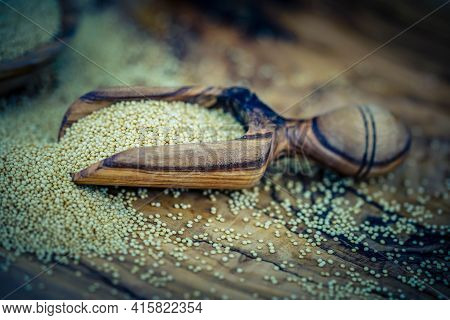 White Amaranth Seed On Brown Olive Wood