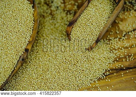 White Amaranth Seed On Brown Olive Wood