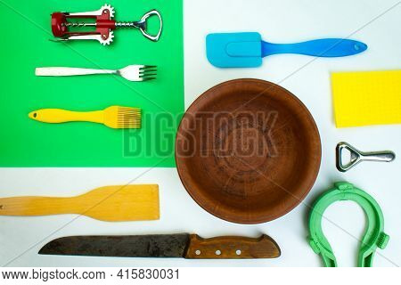 Background Of Kitchen Utensils On White Wooden Kitchen Table. Tools. Top View.